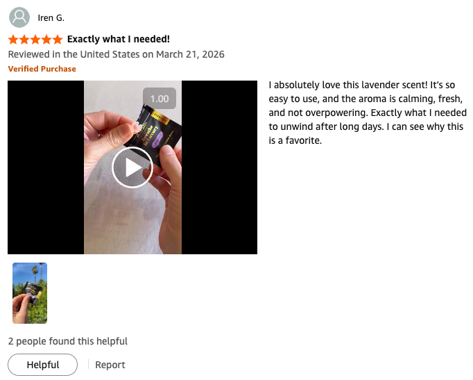A product review on Amazon for a lavender-scented item. The review contains a video thumbnail showing a hand holding a small dark packet, a star rating, a verified purchase badge, a customer comment praising the calming lavender scent, and a small inset photo.
