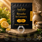Auralis lemon nasal diffuser ring and pouch on stone with fresh lemons, citrus blossoms and a lit oil burner