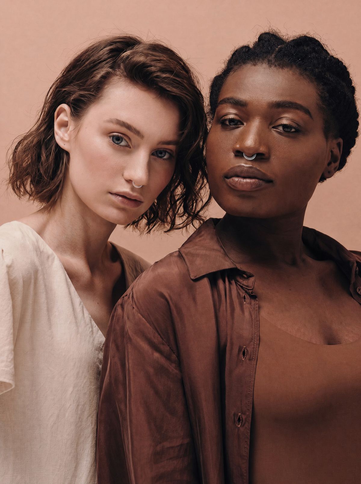Auralis clear silicone nasal diffuser rings worn by two women in a luxury aromatherapy wellness lifestyle photo.