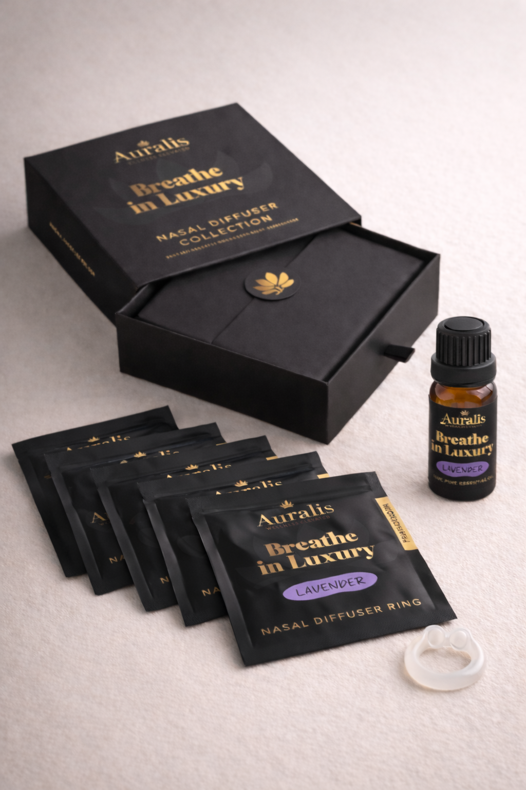 Auralis Signature Set in Lavender featuring essential oil bottle, five scented pouches, clear silicone wearable nasal aromatherapy ring, and packaging box