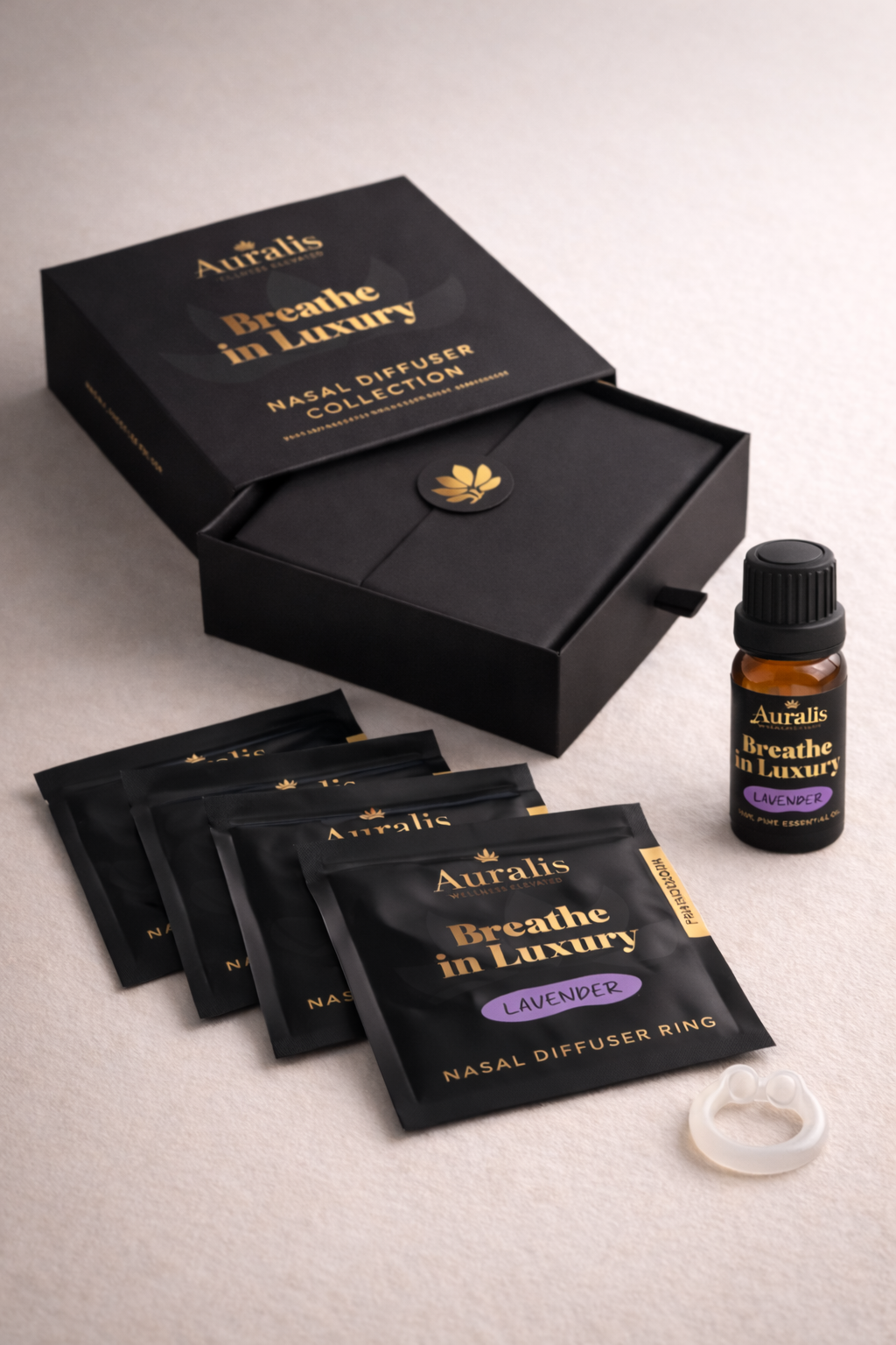 Auralis Signature Set in Lavender featuring essential oil bottle, five scented pouches, clear silicone wearable nasal aromatherapy ring, and packaging box