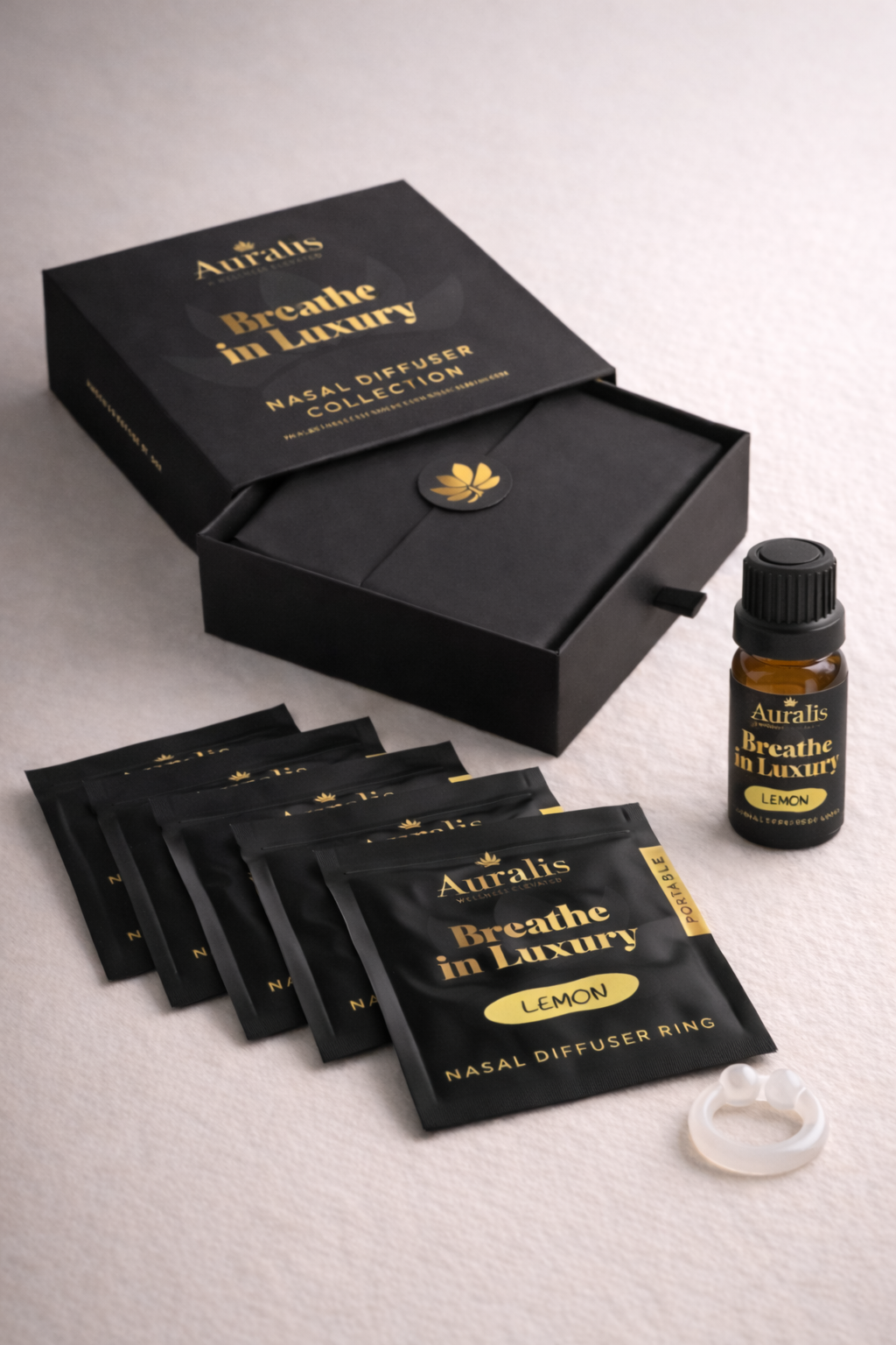 Auralis Signature Set in Lemon featuring essential oil bottle, five scented pouches, clear silicone wearable nasal aromatherapy ring, and packaging box