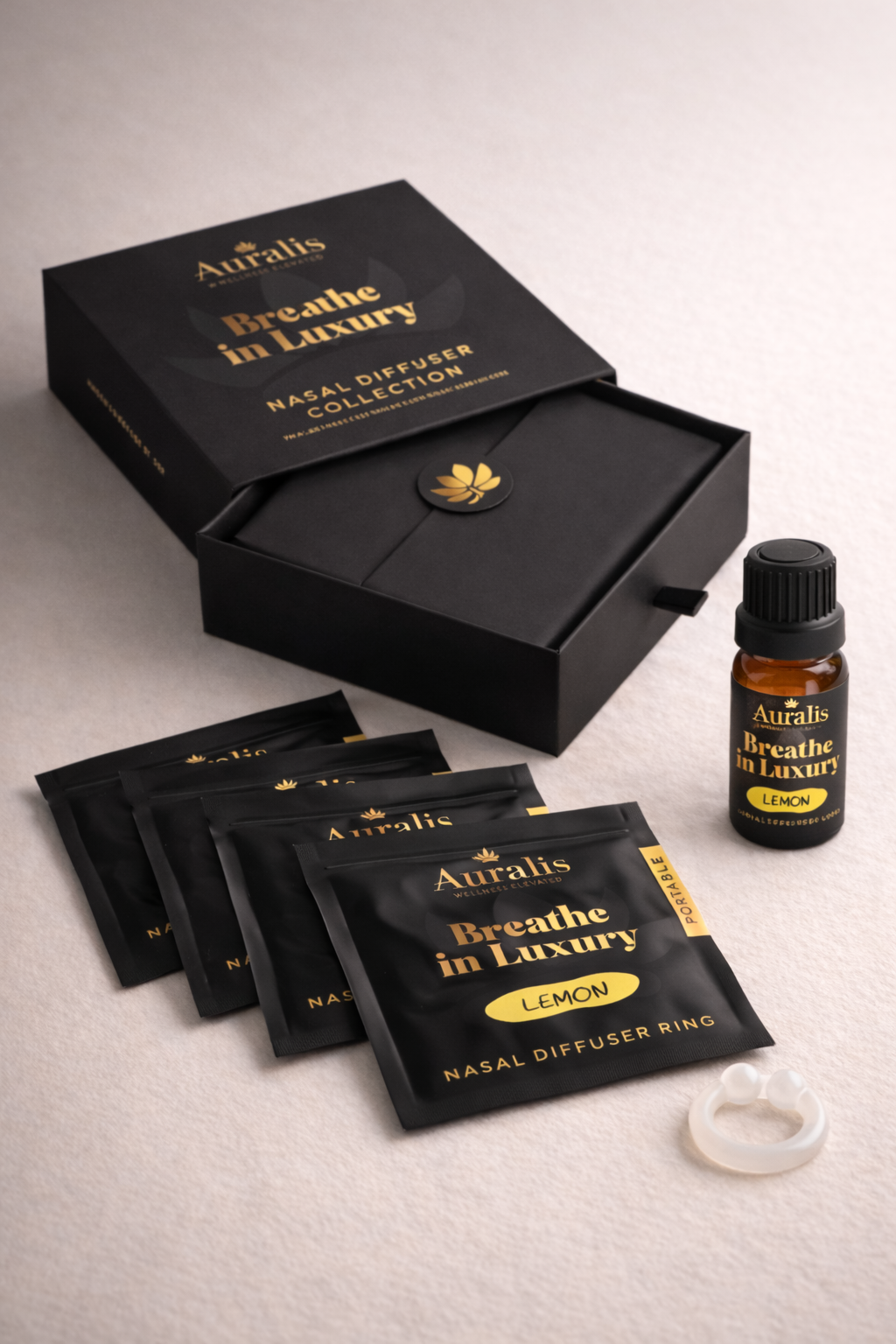 Auralis Signature Set in Lemon featuring essential oil bottle, five scented pouches, clear silicone wearable nasal aromatherapy ring, and packaging box