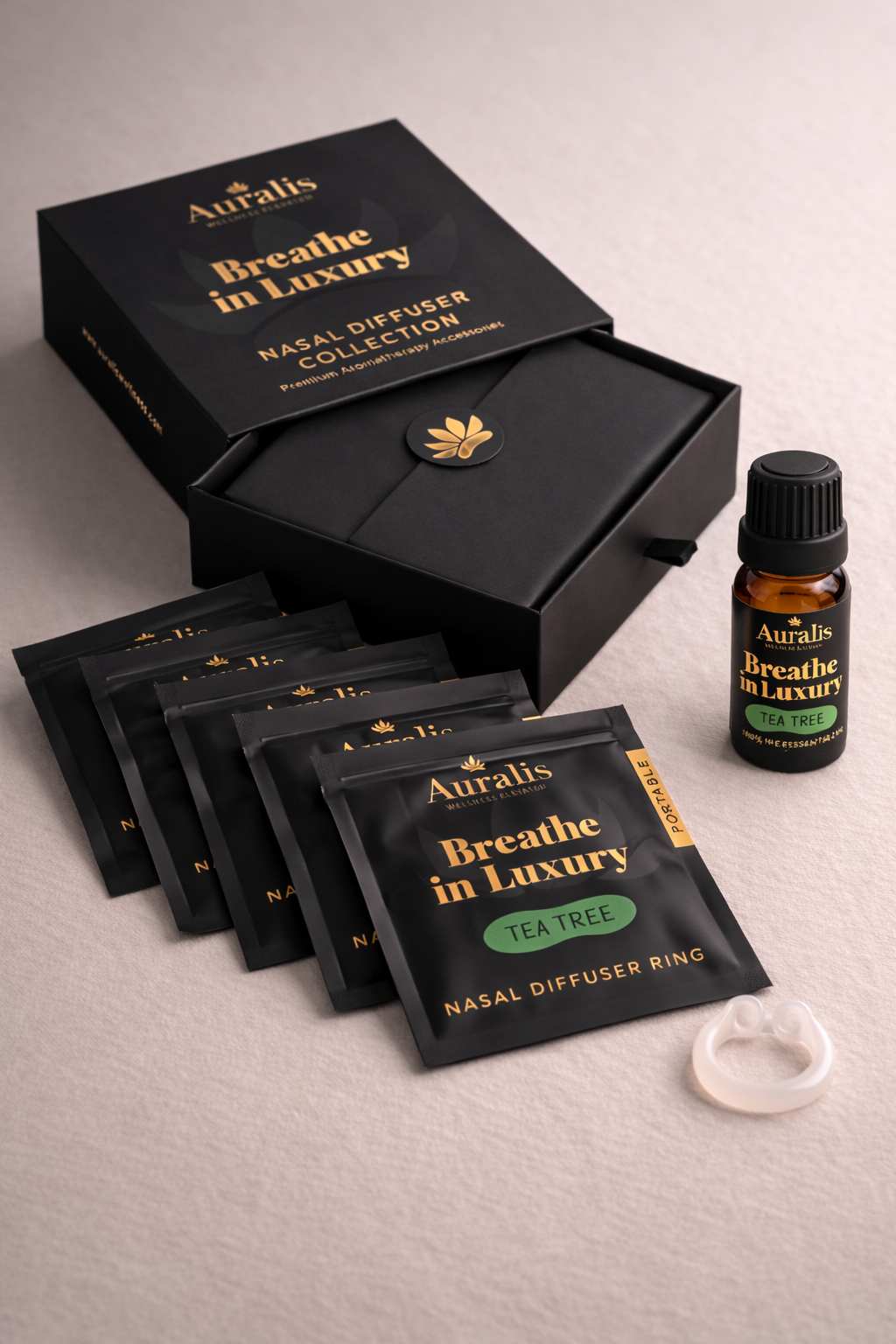 Auralis Signature Set in Tea Tree featuring essential oil bottle, five scented pouches, clear silicone wearable nasal aromatherapy ring, and packaging box
