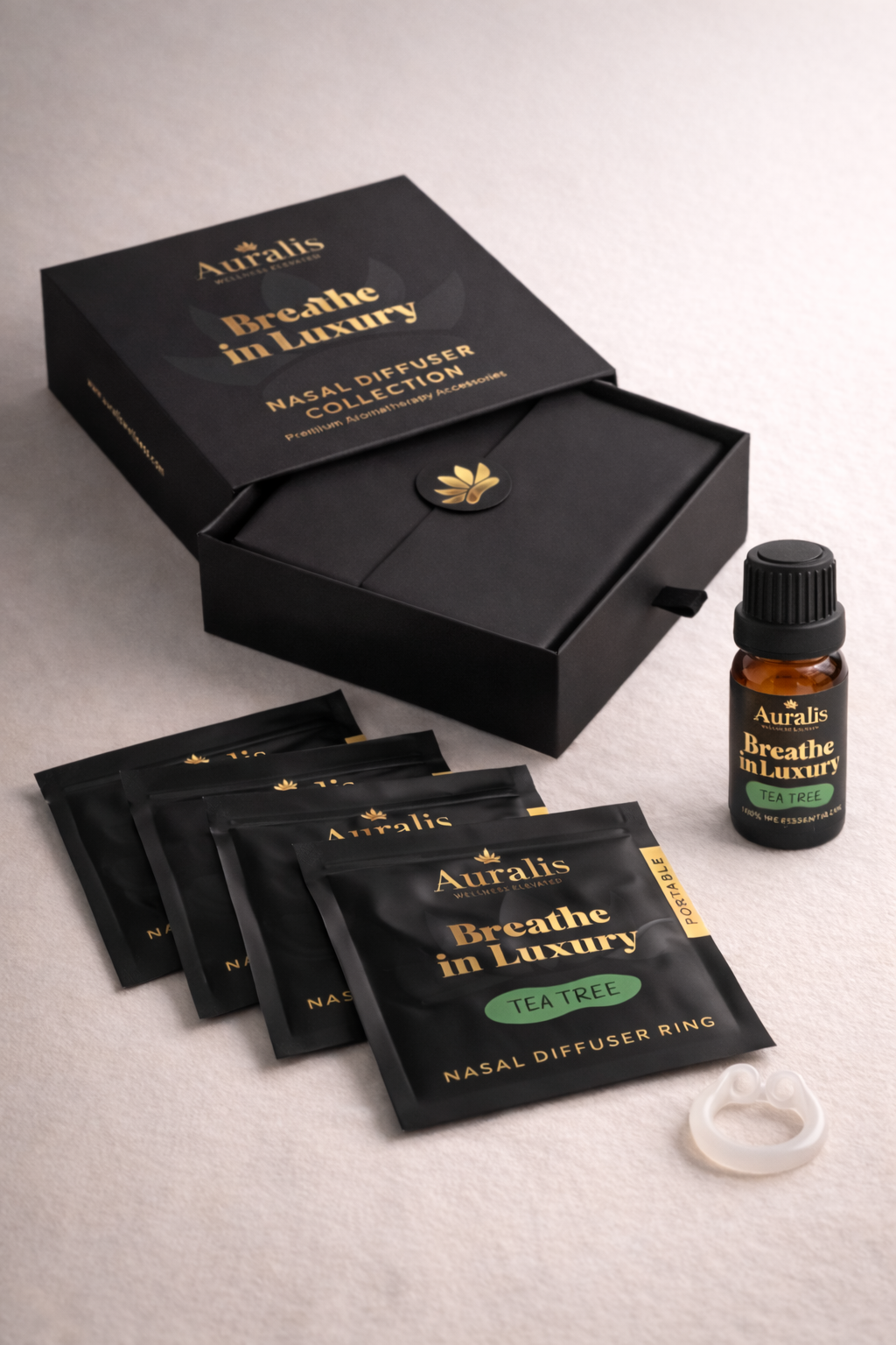 Auralis Signature Set in Tea Tree featuring essential oil bottle, five scented pouches, clear silicone wearable nasal aromatherapy ring, and packaging box